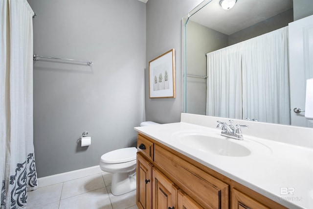 full bath with toilet, tile patterned flooring, baseboards, and vanity