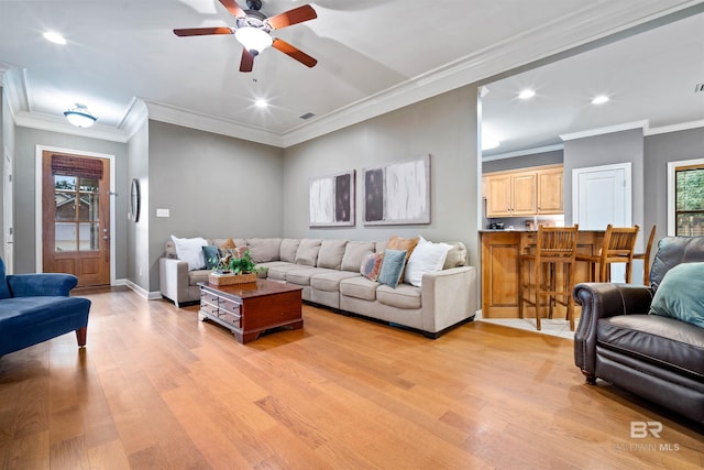 living area featuring recessed lighting, baseboards, and light wood finished floors