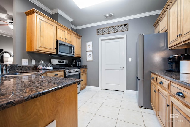 kitchen featuring light tile patterned floors, stainless steel appliances, a sink, visible vents, and crown molding