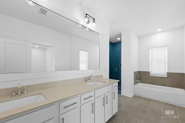 4645 Casablanca Dr, Orange Beach, AL 36561 - full bath featuring healthy amount of natural light, tile patterned flooring, a bath, double vanity, and recessed lighting