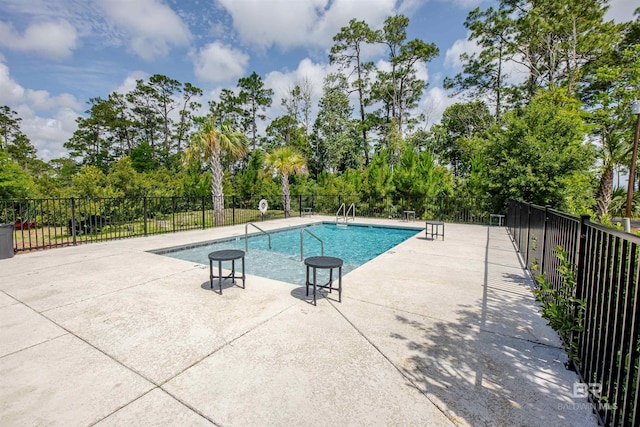 4645 Casablanca Dr, Orange Beach, AL 36561 - community pool featuring fence, view of wooded area, and a patio area