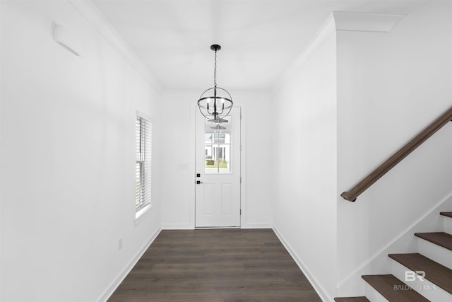 4645 Casablanca Dr, Orange Beach, AL 36561 - foyer with a chandelier, stairs, dark wood-type flooring, baseboards, and crown molding