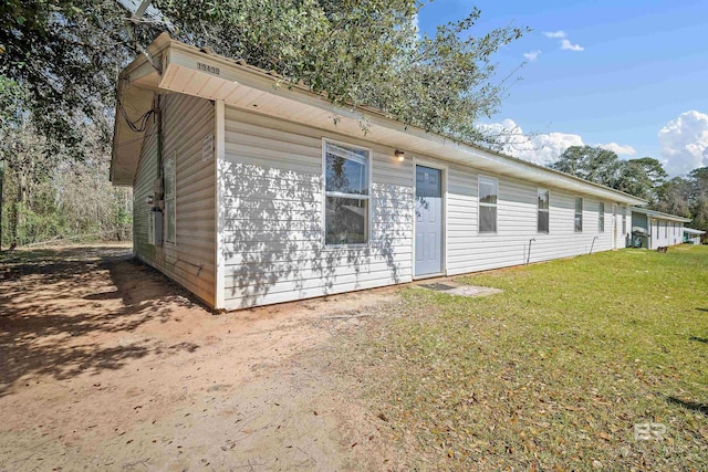 rear view of property featuring a yard