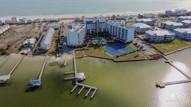 birds eye view of property with a water view and a beach view