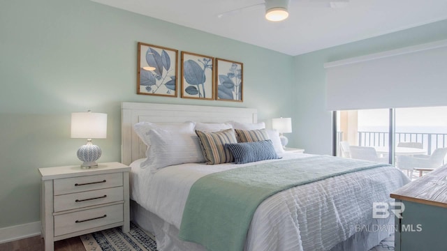 bedroom featuring baseboards, wood finished floors, a ceiling fan, and access to outside