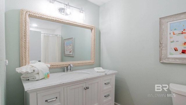 bathroom featuring vanity and toilet