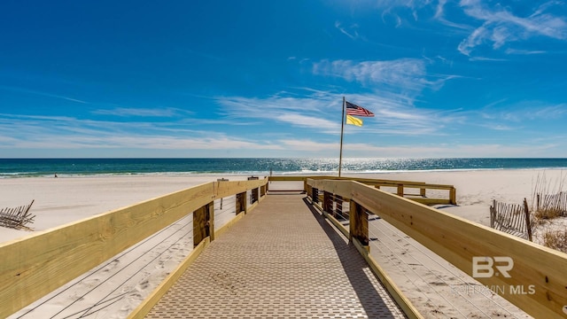 dock area with a water view and a view of the beach