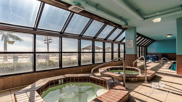 sunroom with visible vents and a hot tub