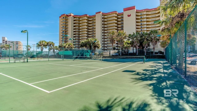 view of tennis court with fence