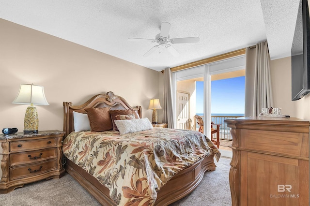 bedroom with light carpet, access to outside, expansive windows, a textured ceiling, and ceiling fan