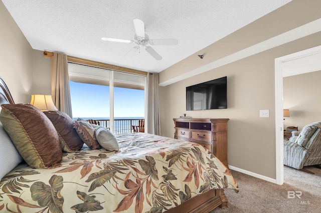 carpeted bedroom featuring ceiling fan, baseboards, a textured ceiling, and access to exterior