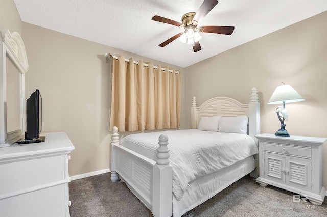 carpeted bedroom with a textured ceiling, baseboards, and ceiling fan