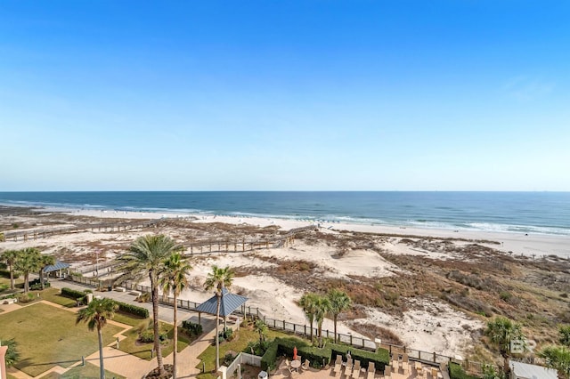 property view of water with a view of the beach and fence