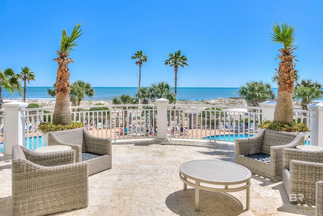 view of patio featuring a fenced in pool and a water view