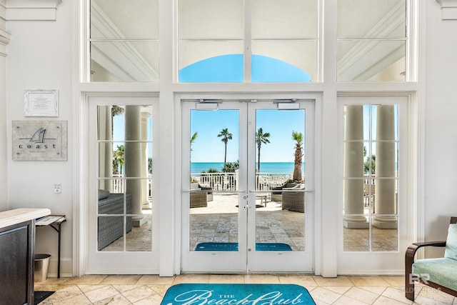 doorway to outside featuring french doors, a water view, and tile patterned flooring