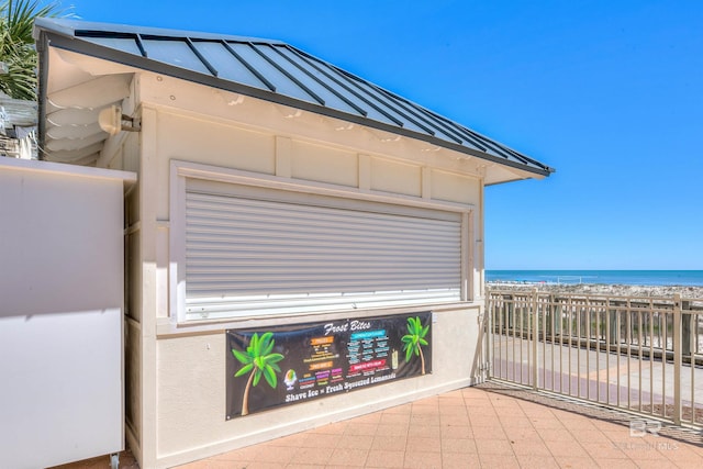 view of patio featuring a beach view and a water view