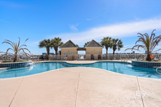 pool featuring a patio area and fence