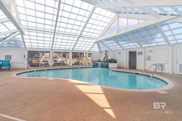 pool featuring glass enclosure, a patio area, and a pergola