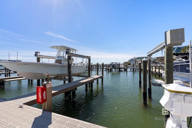 dock area with a water view and boat lift