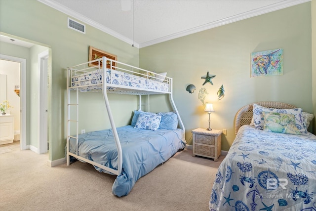 carpeted bedroom featuring baseboards, visible vents, and crown molding