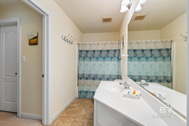 bathroom with tile patterned flooring, visible vents, vanity, and baseboards