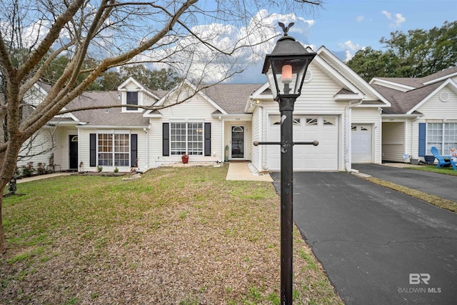 view of front of house featuring a garage and a front lawn