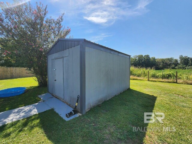 view of outdoor structure with a lawn