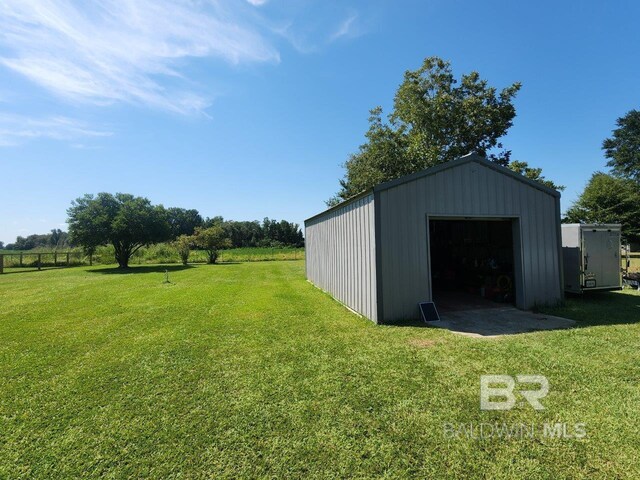 view of outbuilding featuring a lawn