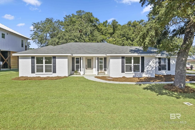 ranch-style house with a front lawn and brick siding