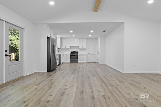 kitchen with white cabinets, light wood-style flooring, appliances with stainless steel finishes, open floor plan, and light countertops