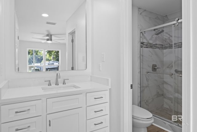 full bath with a stall shower, visible vents, vanity, and toilet