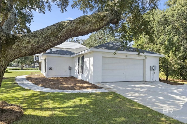 view of home's exterior with a garage, a yard, brick siding, and driveway