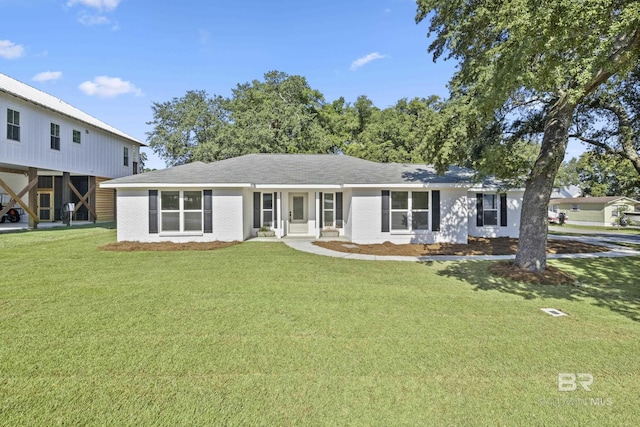 view of front facade with a front lawn and a carport