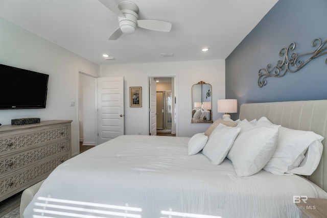 bedroom with ensuite bath, ceiling fan, and hardwood / wood-style floors