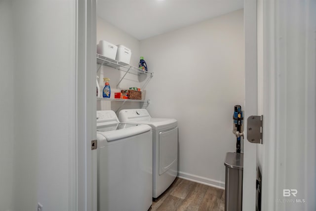 laundry area with washing machine and dryer and dark hardwood / wood-style floors