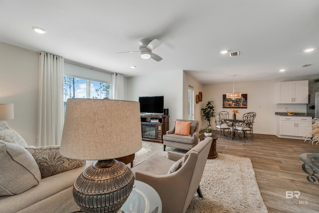 living room featuring light hardwood / wood-style floors and ceiling fan