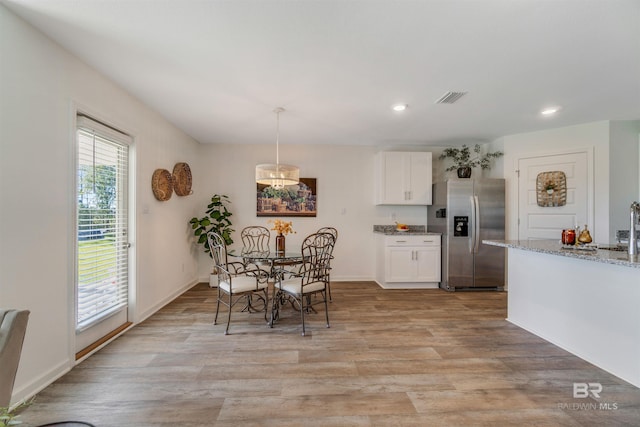 dining space with light hardwood / wood-style flooring