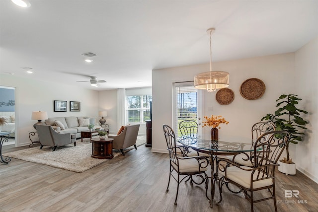 dining space featuring hardwood / wood-style flooring and ceiling fan