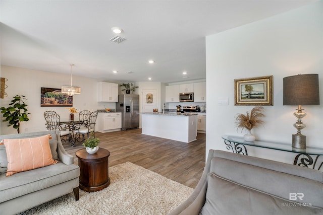 living room featuring light wood-type flooring and sink