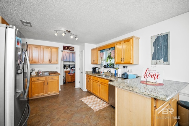 16596 Sugar Loop, Foley, AL 36535 - kitchen with light stone counters, appliances with stainless steel finishes, a sink, visible vents, and a peninsula