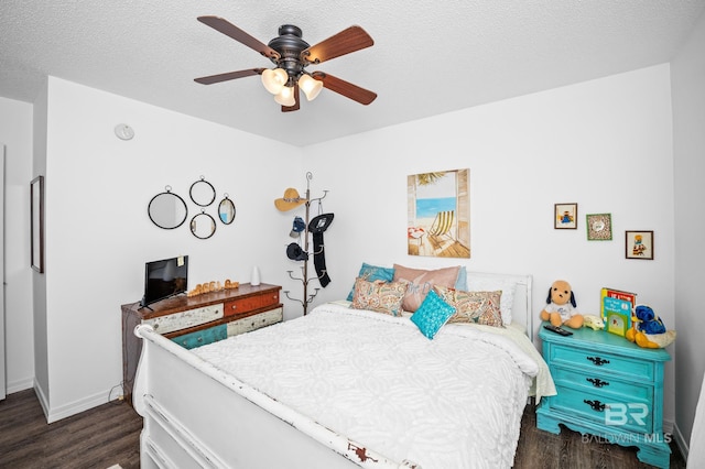 16596 Sugar Loop, Foley, AL 36535 - bedroom featuring baseboards, ceiling fan, a textured ceiling, and dark wood-style flooring