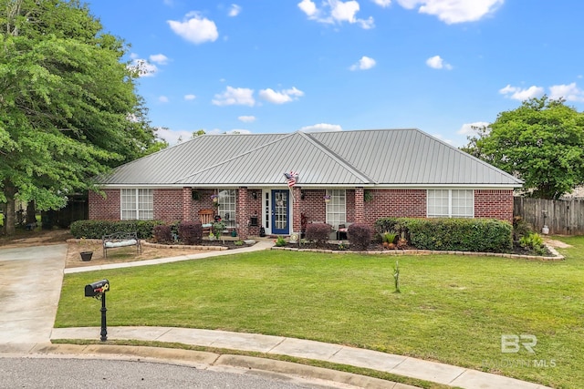 16596 Sugar Loop, Foley, AL 36535 - ranch-style home with brick siding, fence, and a front yard
