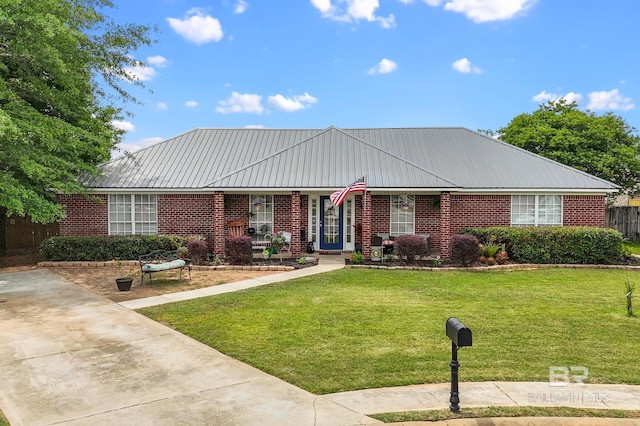 16596 Sugar Loop, Foley, AL 36535 - single story home with metal roof, a front yard, and brick siding