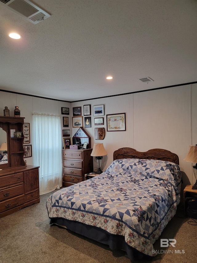 bedroom with a textured ceiling and carpet