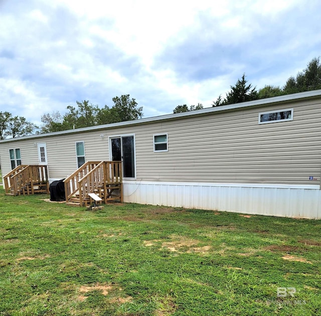 back of house with a lawn