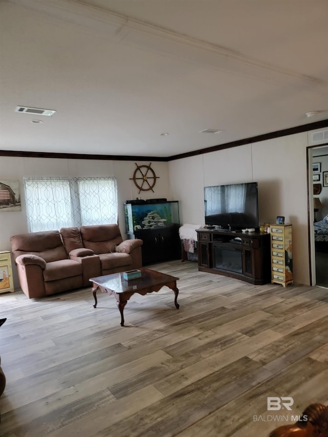 living room featuring ornamental molding and hardwood / wood-style floors