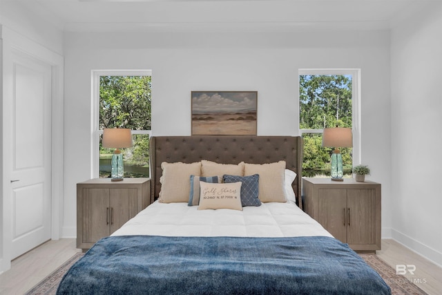 7056 Stone Chase Ln, Gulf Shores, AL 36542 - bedroom featuring ornamental molding, wood finished floors, and multiple windows