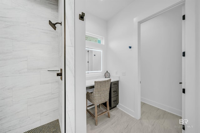 7056 Stone Chase Ln, Gulf Shores, AL 36542 - bathroom featuring vanity, a tile shower, baseboards, and marble finish floor