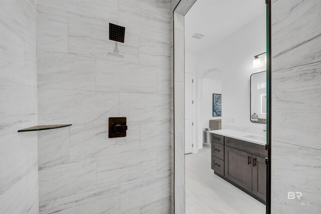 7056 Stone Chase Ln, Gulf Shores, AL 36542 - bathroom with a tile shower, vanity, and visible vents