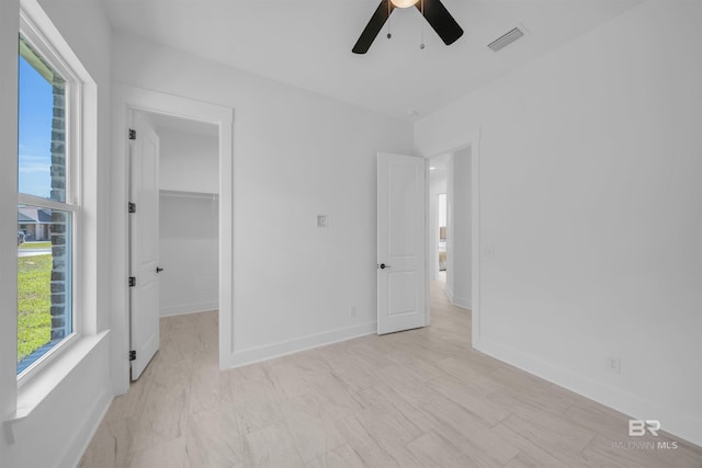 7056 Stone Chase Ln, Gulf Shores, AL 36542 - unfurnished bedroom with baseboards, a ceiling fan, visible vents, and a walk in closet
